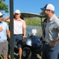 People around golf cart